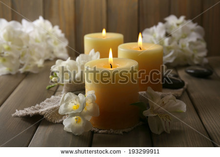 stock-photo-beautiful-candles-with-flowers-on-wooden-background-193299911